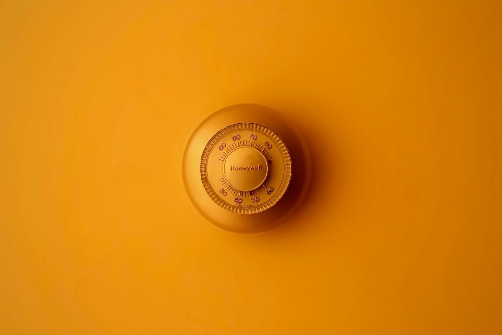 Thermostat on yellow wall