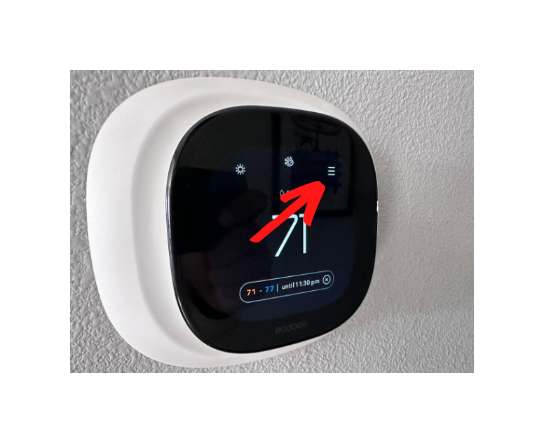 Main screen of the ecobee thermostat with arrow pointing to the menu