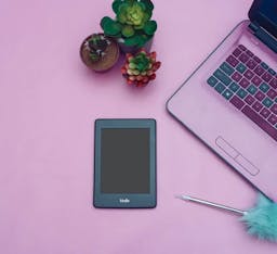 Kindle next to a computer