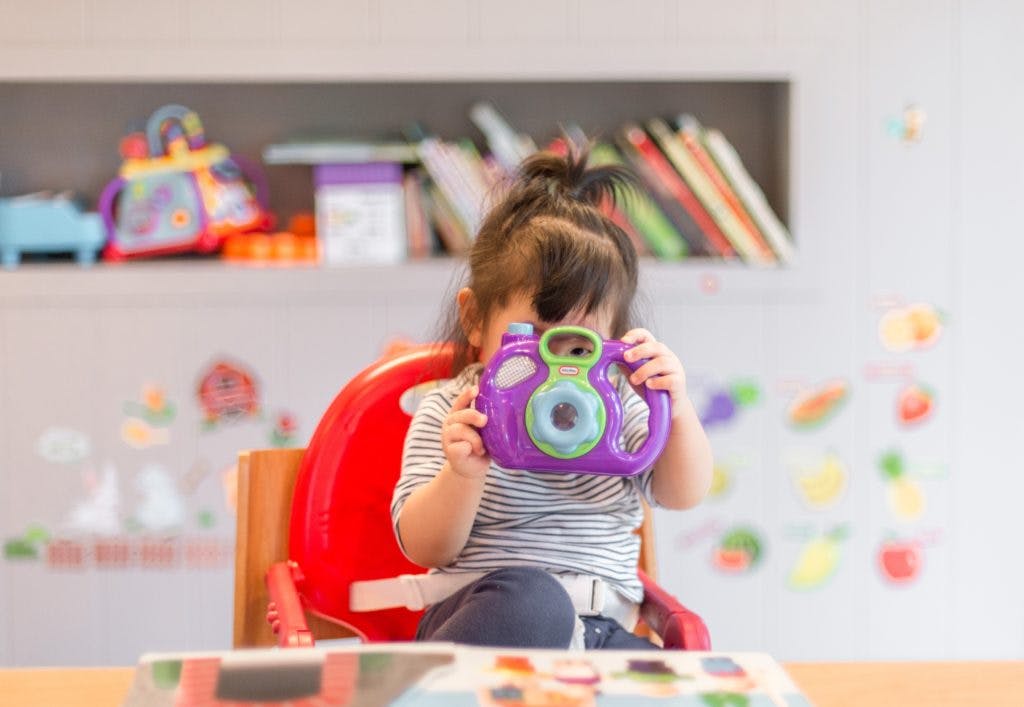 Toddler with a toy camera