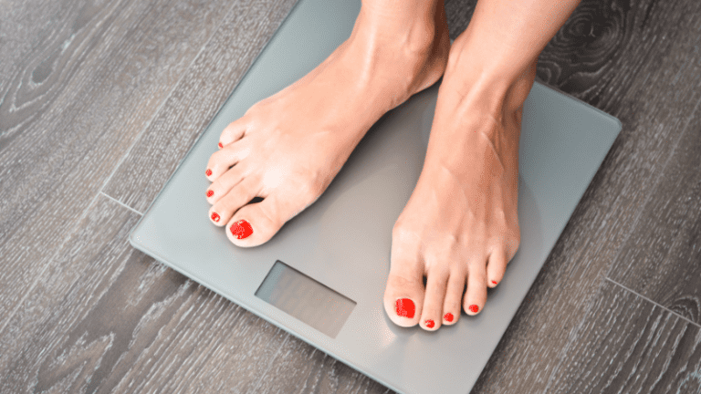 Women on a smart scale with nails painted