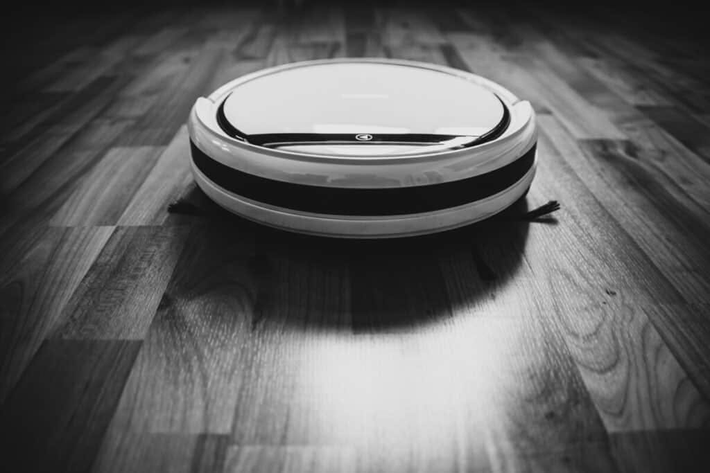 A white and black smart vacuum Roomba i7