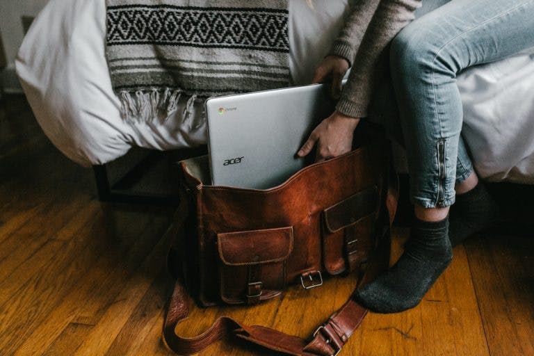 person putting acer laptop in bag