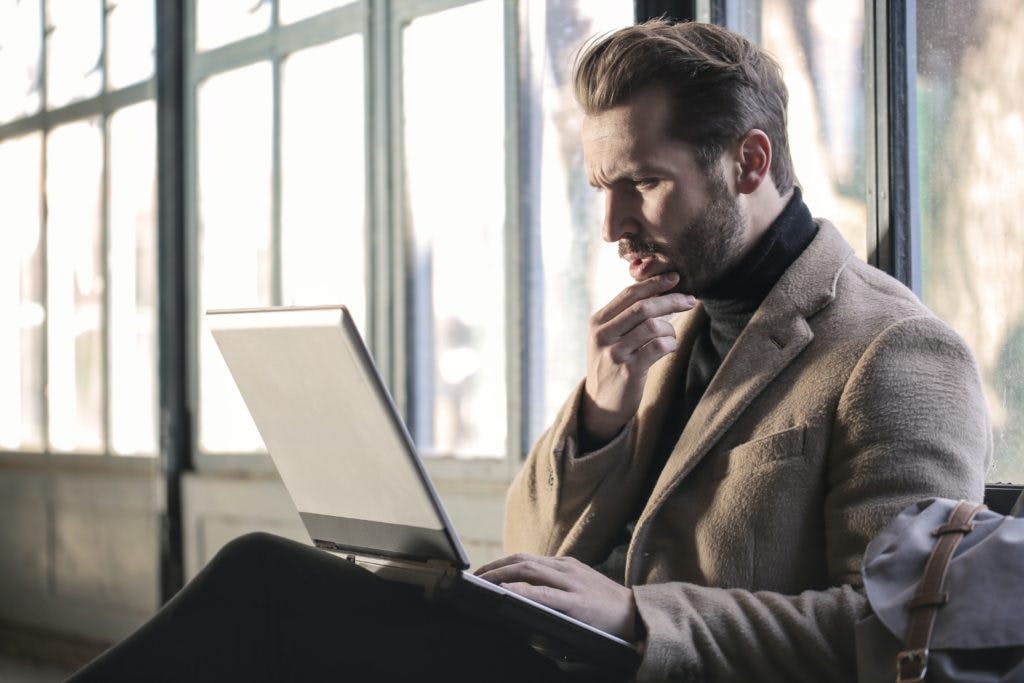 Looking confused/focused at a laptop